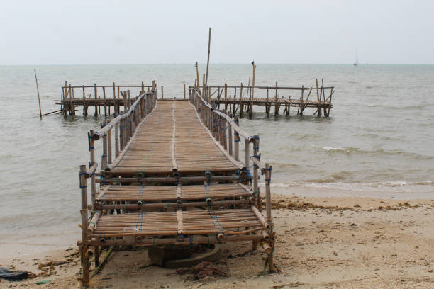 Small and traditional jetty made from bamboo on the beach
