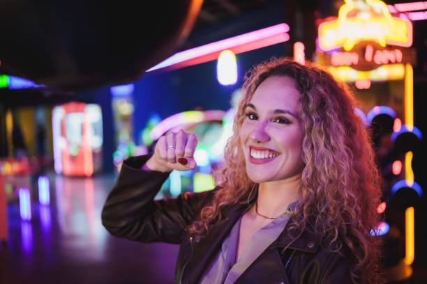 istock Young woman having fun playing punching arcade games in amusement park 2190911263