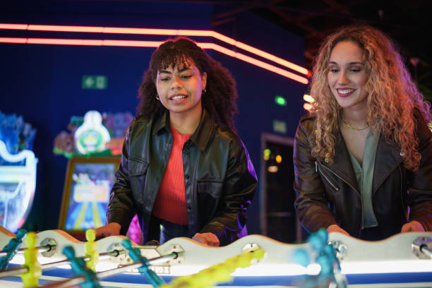 istock Two young women playing table football in an arcade 2190911293