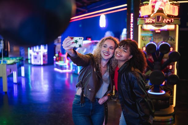 istock Two young women taking a selfie in an amusement arcade 2190911385
