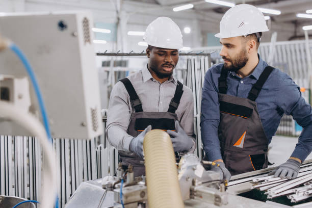 istock Factory workers discussing aluminum and pvc windows and doors production 2190911966