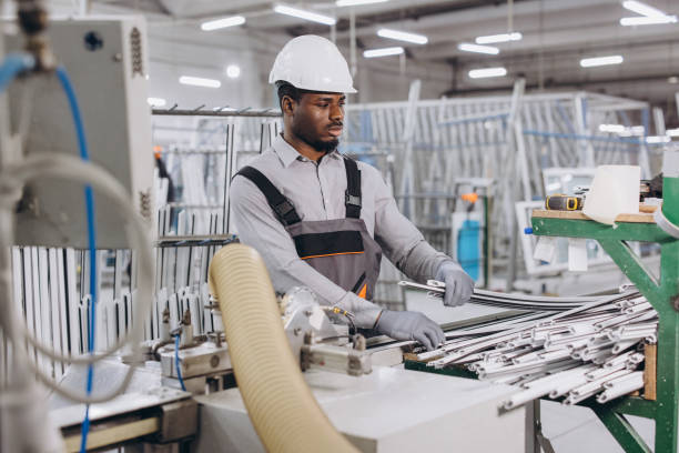 istock Factory worker handling aluminum profiles for windows and doors production 2190912004