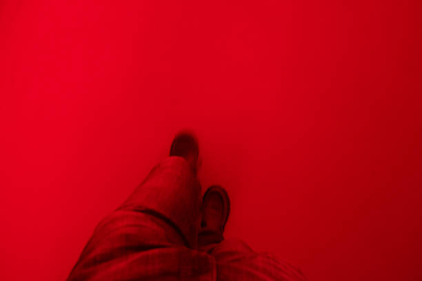 abstract blurred view of legs walking through a red room