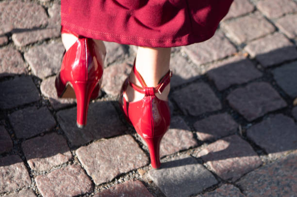 istock Close-up of a woman's legs in red pumps 2190915737
