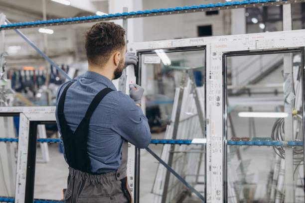 istock Factory worker assembling aluminum and pvc window frame in production line 2190916553