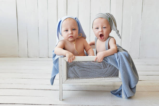 istock Cute funny baby twin boys with bunny ear. Easter rabbit. Children's Day. 2190916841