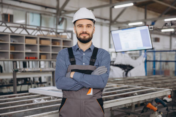 istock Factory worker posing with crossed arms in windows and doors production line 2190916921