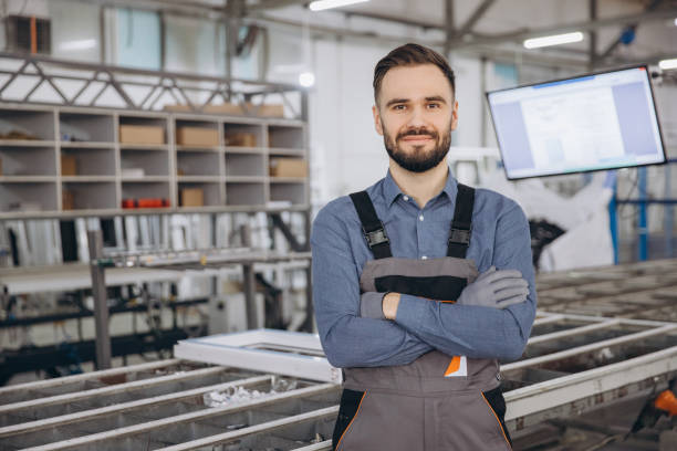 istock Factory worker posing with crossed arms in a PVC windows and doors production line 2190916923