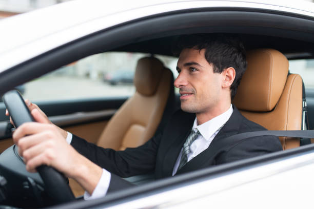 Rear View Of A Male Chauffeur Driving A Car