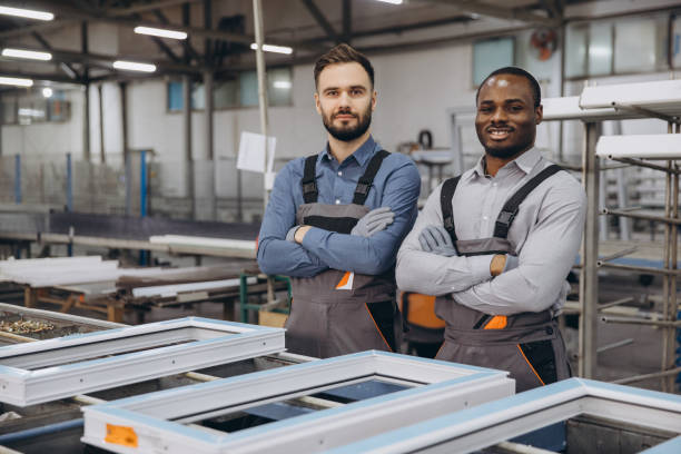 istock Factory workers posing with arms crossed near pvc window frames 2190917641
