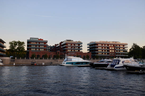 Elegant modern waterfront apartments set alongside exclusive luxurious yachts and tranquil serene water views