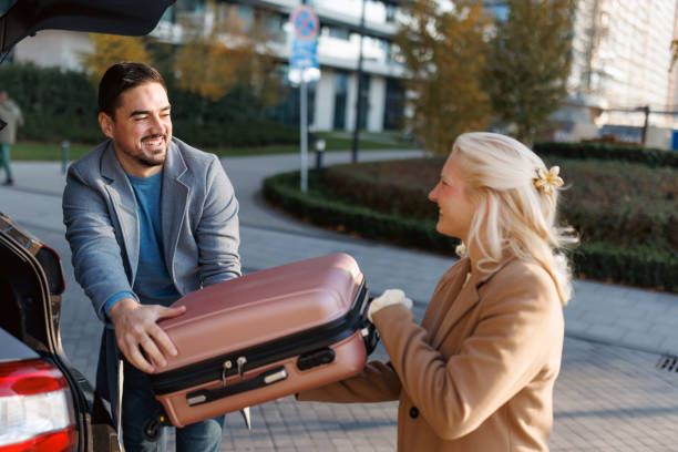 istock Couple loading luggage into car trunk before road trip 2190918927