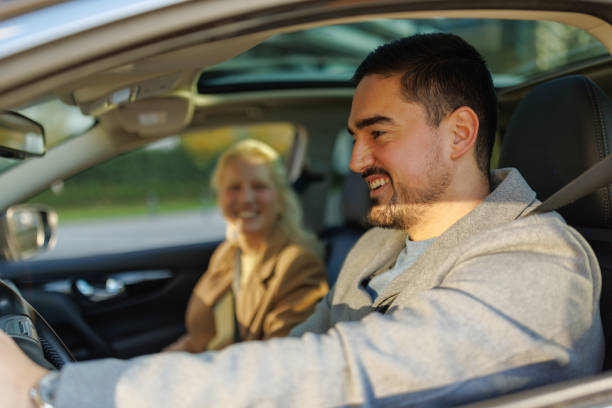 istock Couple driving and smiling during a road trip 2190918995