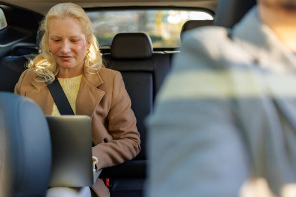 istock Businesswoman working on laptop while traveling by car 2190919049