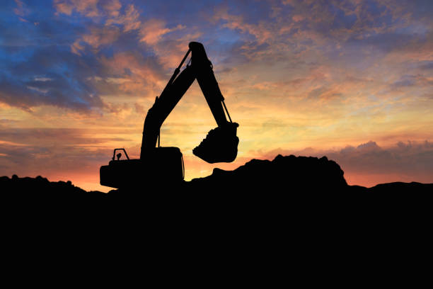 istock Crawler excavators silhouette are digging the soil in the construction site. 2190921146