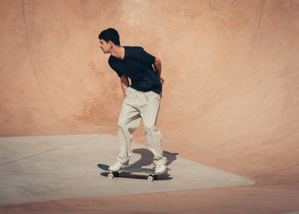 istock young skater wearing black tshirt skating inside a bowl in a skate park. 2190930426