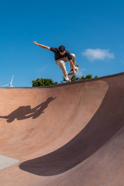 istock young skater wearing black tshirt skating inside a bowl in a skate park. 2190930452