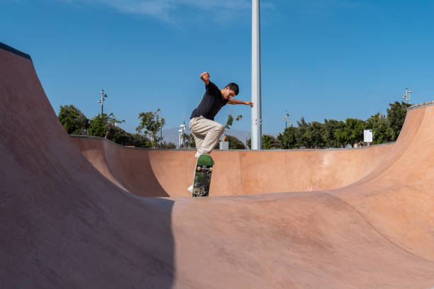 istock young skater wearing black tshirt skating inside a bowl in a skate park. 2190930457
