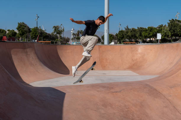 istock young skater wearing black tshirt skating inside a bowl in a skate park. 2190930462