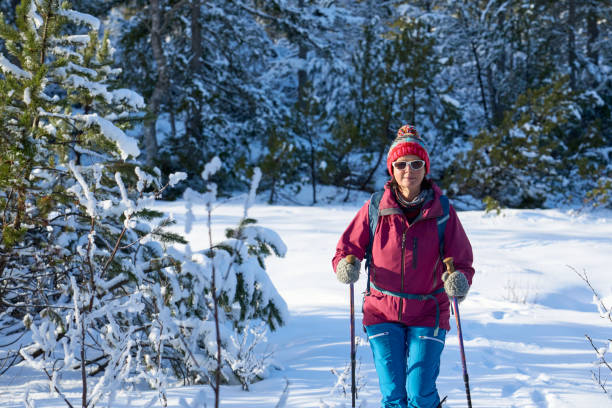 istock woman hiking with in deep powder snow in the Bregenz Forest, Austria 2190931393