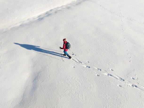 istock woman hiking with in deep powder snow in the Bregenz Forest, Austria 2190931444