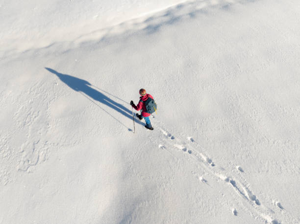 istock woman hiking with in deep powder snow in the Bregenz Forest, Austria 2190931482