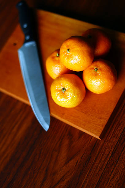 istock Fresh Orange Preparation with Knife and Wooden Board. Stock Image 2190931499
