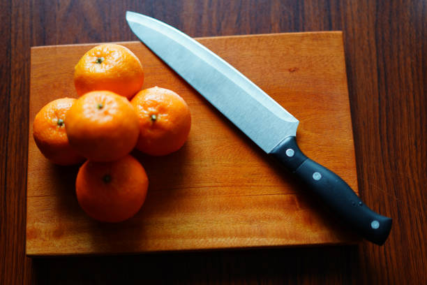 istock Orange Halves on Wooden Board with Knife. High-Resolution Stock Image 2190931599