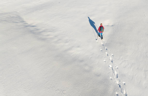 istock woman hiking with in deep powder snow in the Bregenz Forest, Austria 2190931910