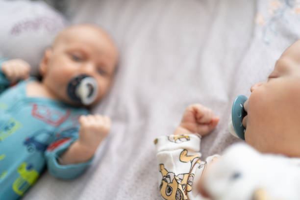 istock Infant twin baby boys lying on sofa 2190932790