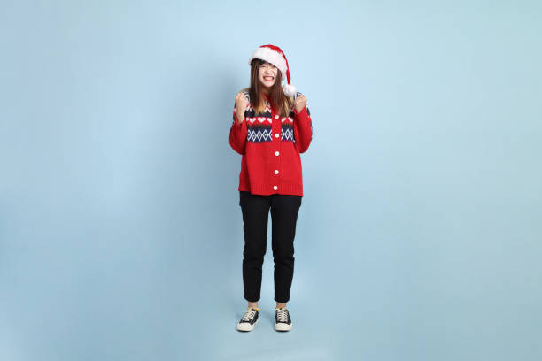 istock Woman wearing Santa hat 2190935391
