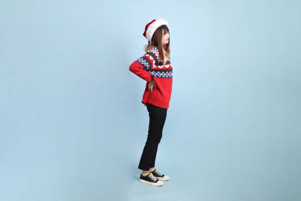 istock Woman wearing Santa hat 2190935399