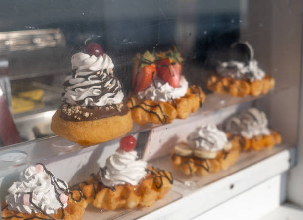 istock Cakes and donuts on display for sale from a food kiosk 2190939023