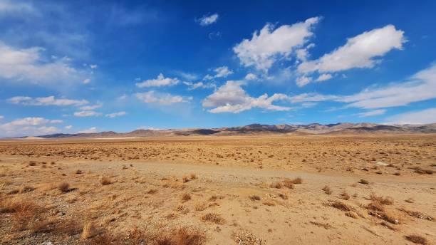 istock Image of a desert with blue sky and white clouds 2190939880