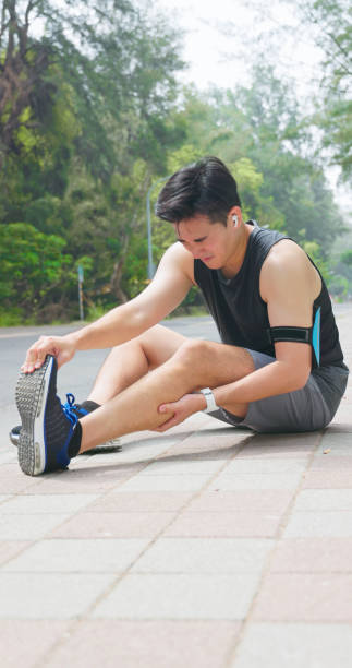 istock asian man sporting calf cramping 2190944947