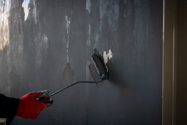 istock painting roller is in male hand with red glove horizontal fixer upper home still 2190945334