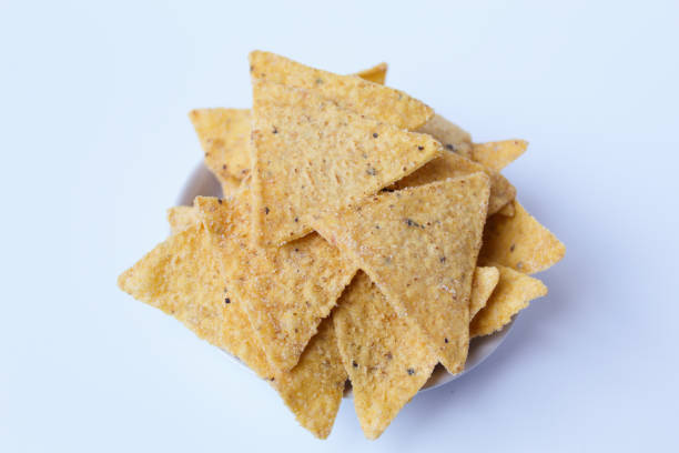 istock Tortilla chips, in triangle shape, on a small white plate. Isolated on white background 2190948900
