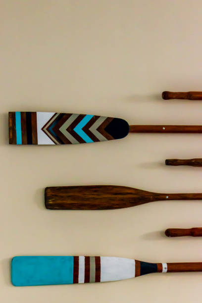 istock Decorative Wooden Paddles with Colorful Design Arranged on Neutral Wall 2190949045