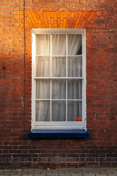 istock White window with curtains, on red brick wall, typical of England, in Canterbury 2190949945