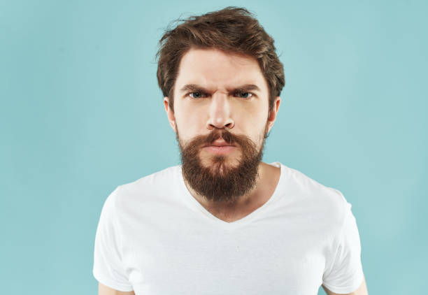 istock bearded man in a white t-shirt hand gestures anger close-up 2190951221