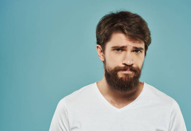 istock bearded man in a white t-shirt hand gestures anger Studio 2190951585
