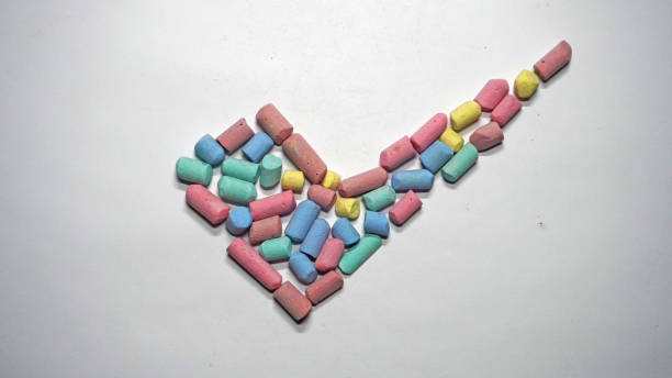 istock Colorful Chalk Pieces Arranged in a Checkmark Shape on White Background 2190951936