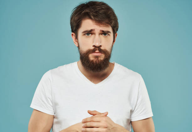 istock emotional man in a white t-shirt irritated facial expression Studio 2190952496