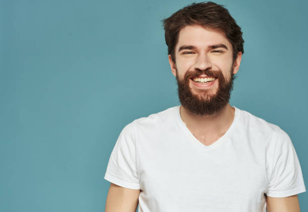 istock emotional man in a white t-shirt hand gestures anger blue background 2190952606