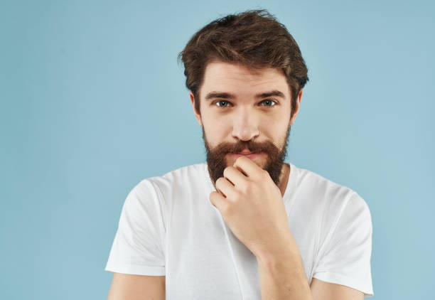 bearded man in a white t-shirt hand gestures close-up. High quality photo