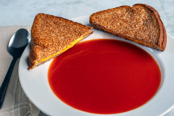 tomato soup  served with a  grilled cheese sandwi