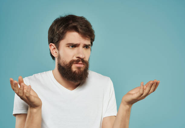 istock Man in a white t-shirt expressive look discontent Studio 2190953599