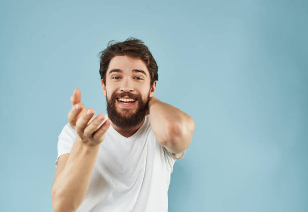 istock Man in a white t-shirt happy facial expression blue background 2190953706