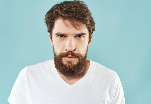 istock emotional man in a white t-shirt expressive look discontent Lifestyle 2190953791