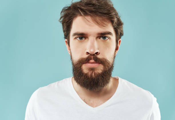 istock Man in a white t-shirt hand gestures anger blue background 2190953831